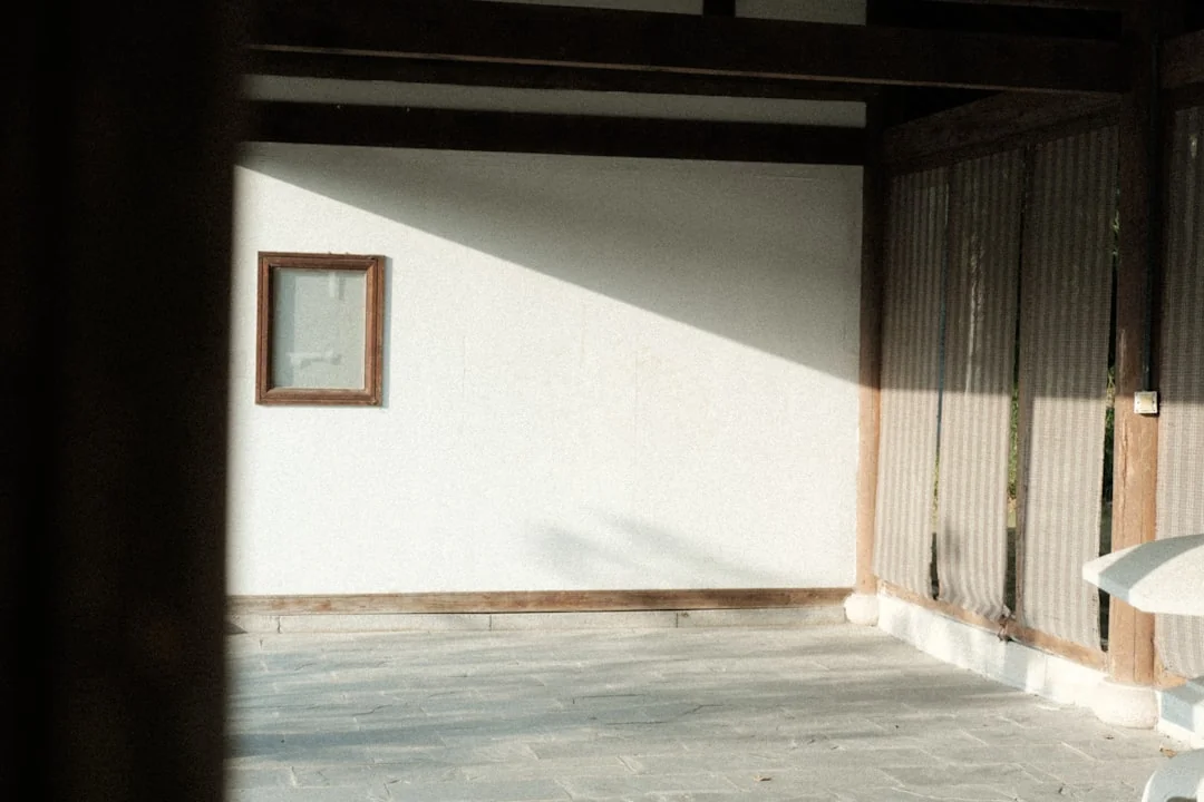 Close-up of people cleaning wooden floor with broom and dustpan indoors.